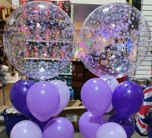 Purple and lavender balloon bouquets with confetti bubble balloons